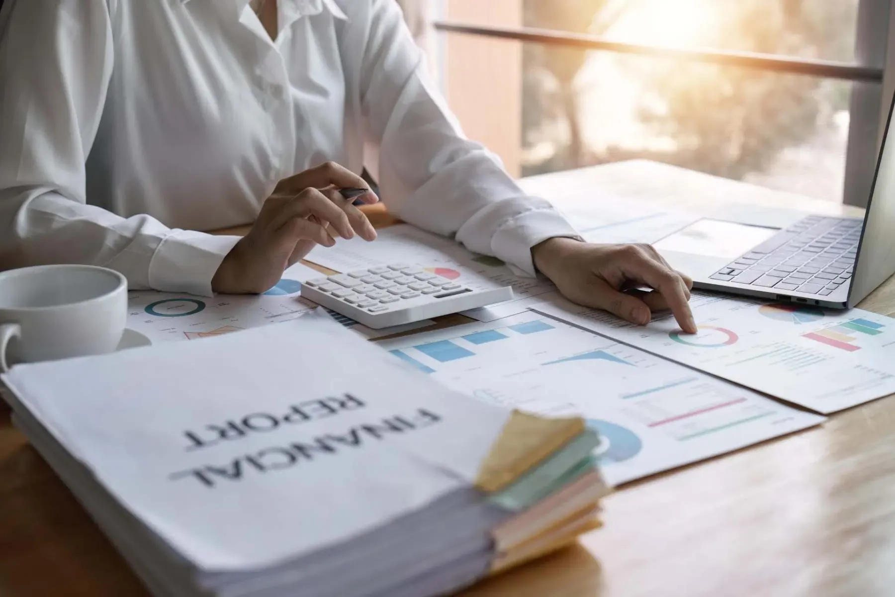 Accountant working on a calculator giving business advice McGrath Pattison Accountants Maghera